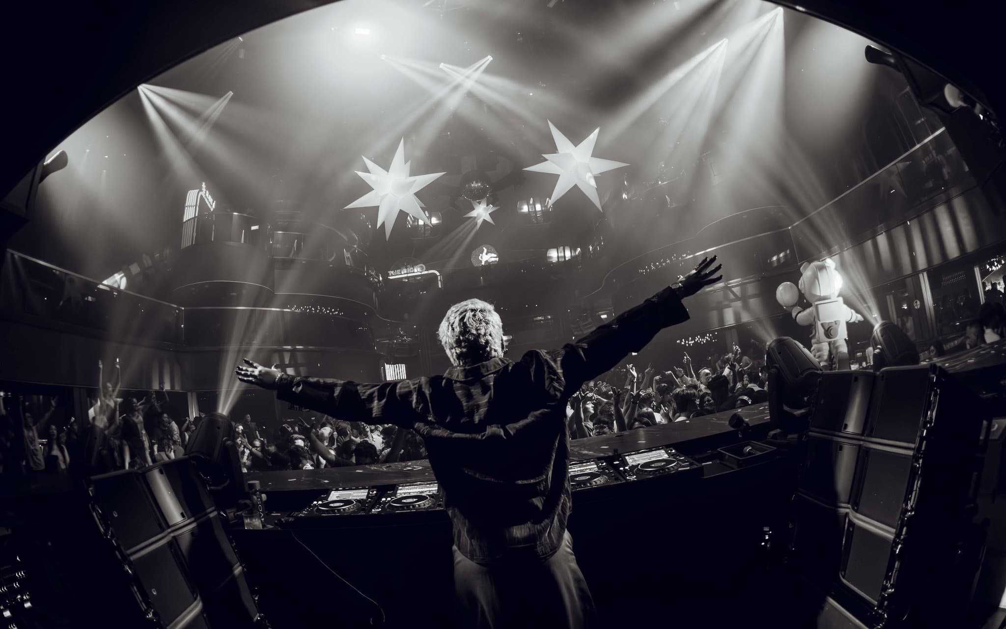 NASH.D performing in front of a nightclub crowd